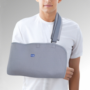 A person wearing a grey arm sling