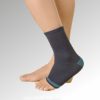 A person is wearing a black Comfort Ankle Support