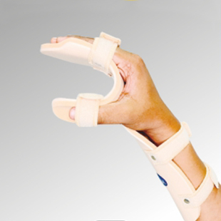 A person's hand wearing a beige resting brace