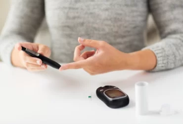 women looking diabetics using device