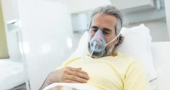 An old man wearing oxygen mask