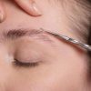 Shaping Eyebrows with Cuticle Scissors